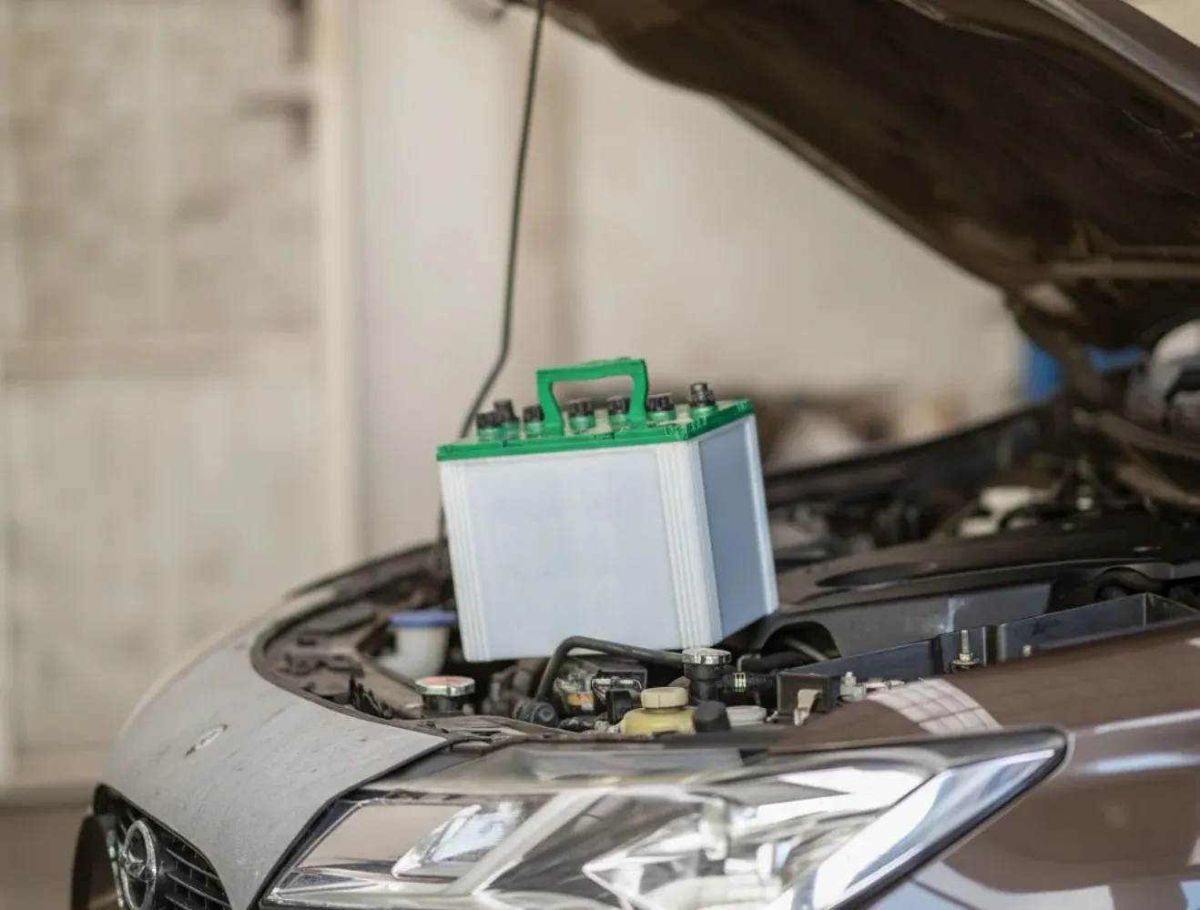New battery set on the engine of a car