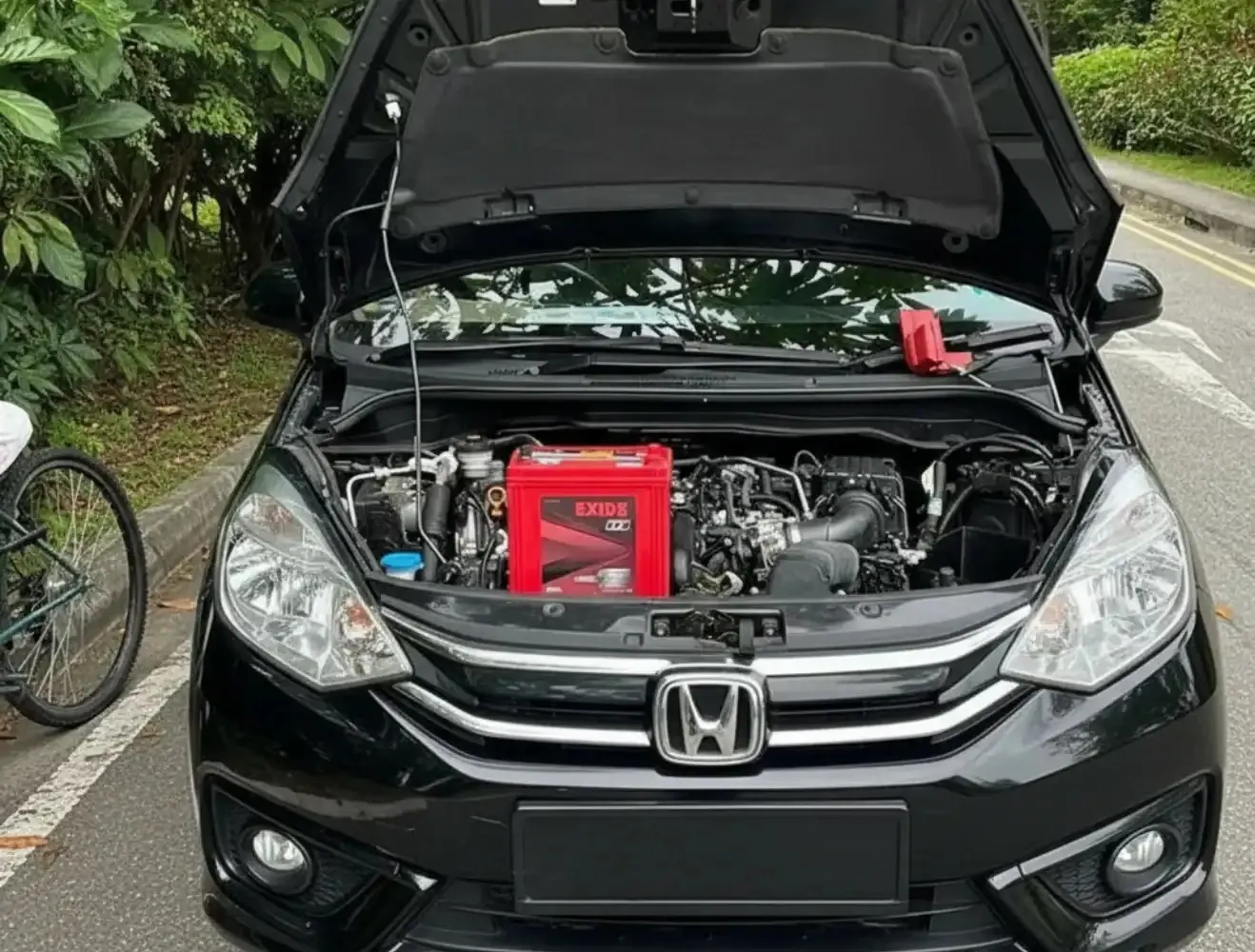 Picked to fit the car Honda with its bonnet open and a red battery