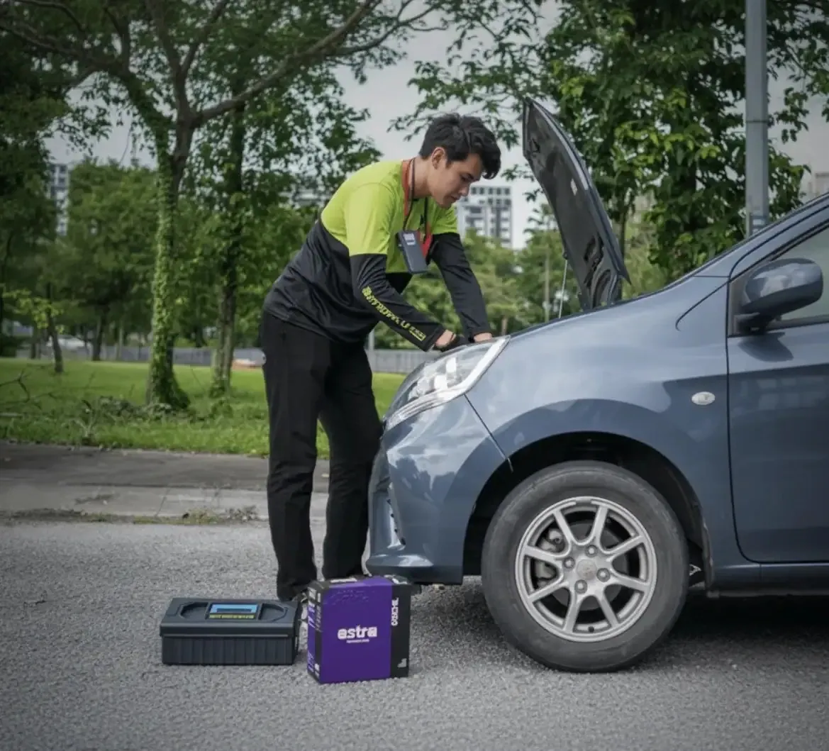 Technician working on a car with a jump pack