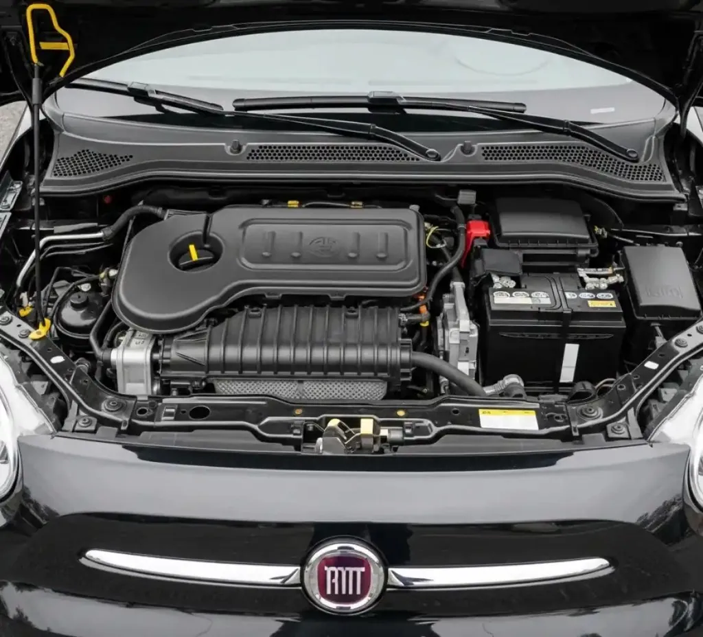 Before the work starts on a Fiat Fiat engine bay with the battery in view