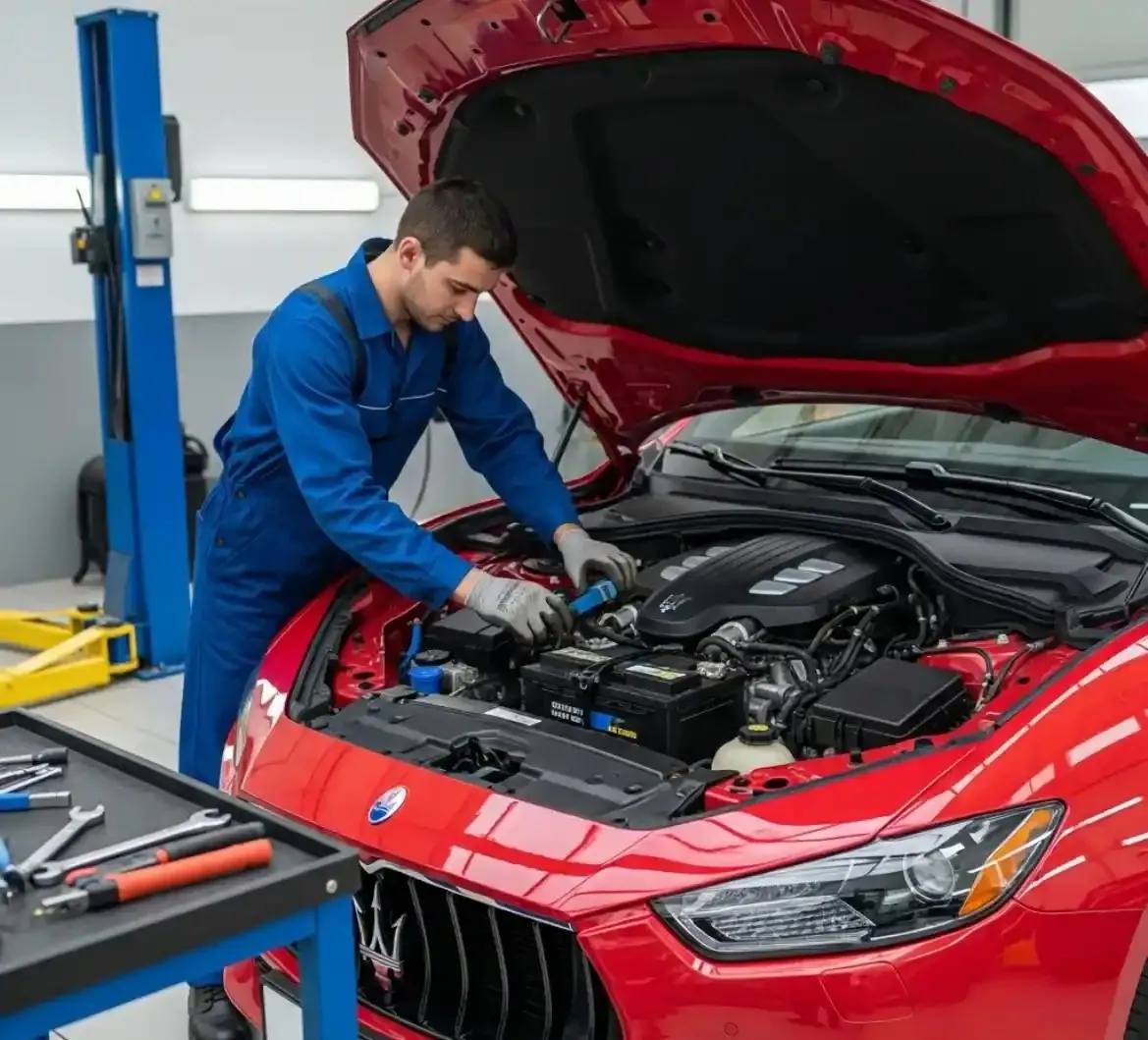 Technician working on a red Maserati